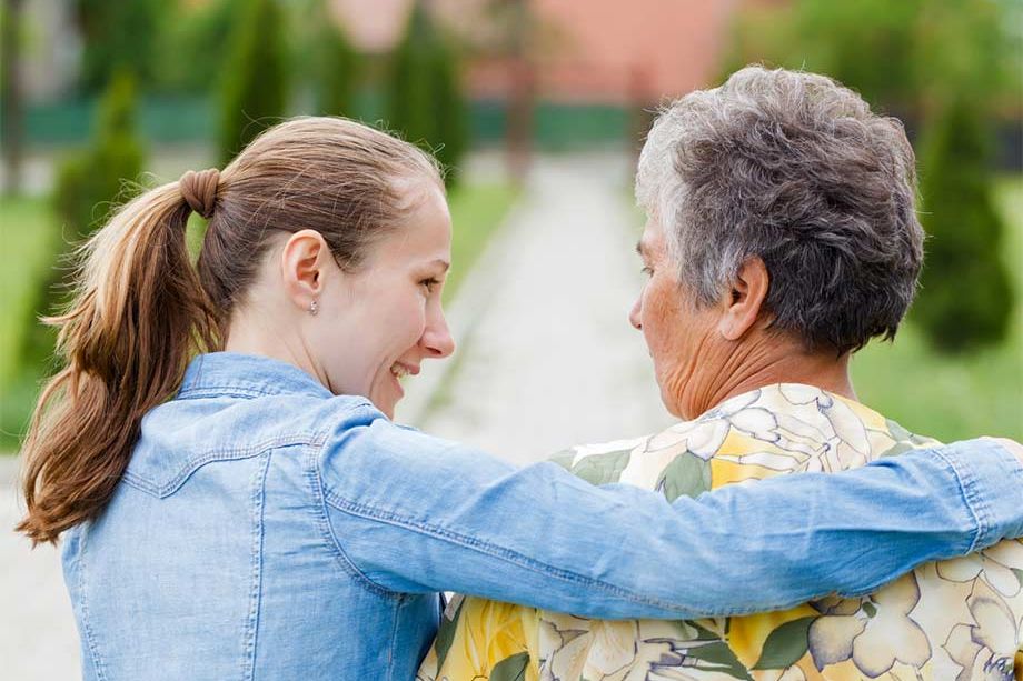 Caregiver providing respite care support to a happy senior