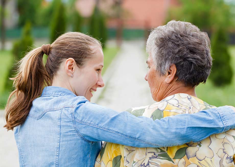 Caregiver providing respite care support to a happy senior